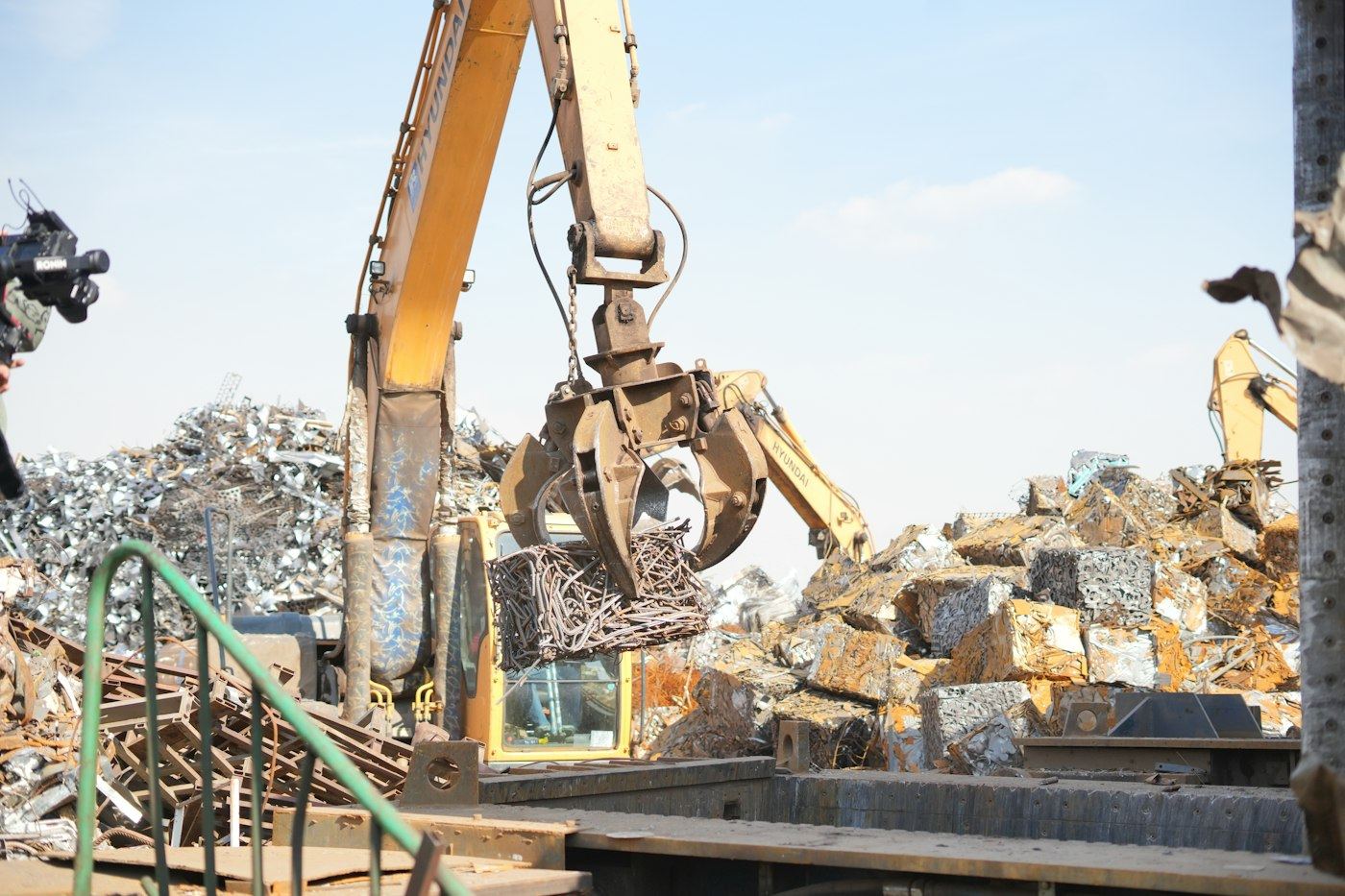 An excavator collecting scrap metal